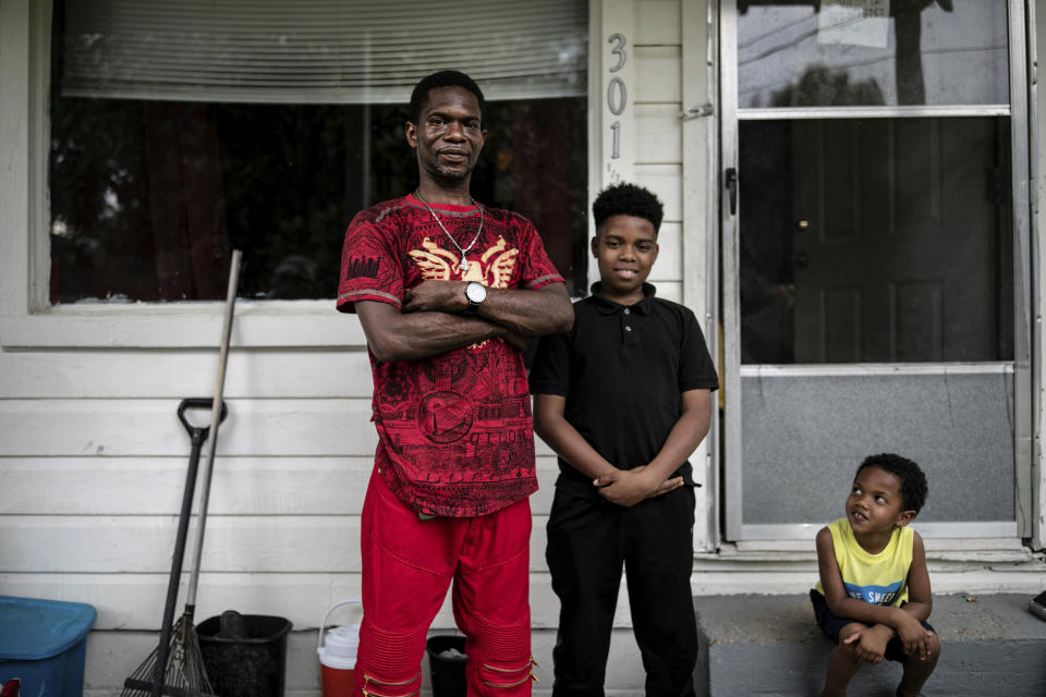 Joshua K. Love stands with his son, Joshua K. Love Jr., center, and his nephew, Mason Martinez, on the front porch of his home in Greenwood, Miss., Saturday, June 8, 2019. “I tell my son I want him to be a better man than I am,” the elder Love says. “I don’t want him living my broken dreams.” (AP Photo/Wong Maye-E)