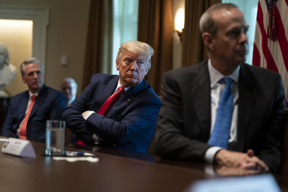 House Minority Leader Kevin McCarthy of Calif., President Donald Trump, and Chevron CEO Mike Wirth listen during a meeting with energy sector business leaders in the Cabinet Room of the White House, Friday, April 3, 2020, in Washington. (AP Photo/Evan Vucci)