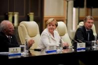 German Chancellor Angela Merkel (C) looks on after her meeting with Chinese President Xi Jinping (not pictured) at the West Lake State House on the sidelines of the G20 Summit, in Hangzhou, Zhejiang province, China, September 5, 2016. REUTERS/Etienne Oliveau/Pool