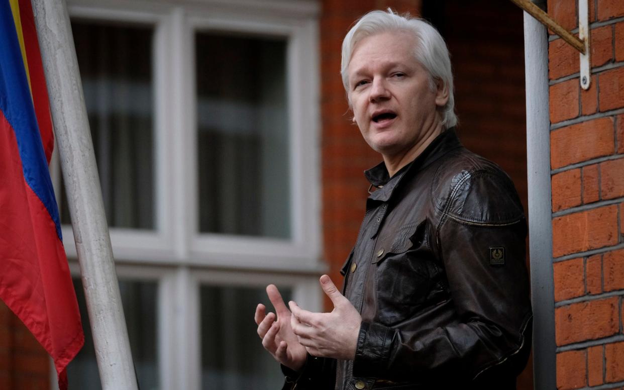 Julian Assange reads a prepared statement from the balcony at the Ecuadorian Embassy in London in May  - Christopher Pledger