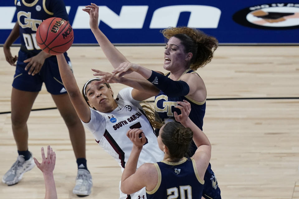 South Carolina forward Victaria Saxton, left, and Georgia Tech forward Lorela Cubaj, back right, battle for a rebound during the first half of a college basketball game in the Sweet Sixteen round of the women's NCAA tournament at the Alamodome in San Antonio, Sunday, March 28, 2021. (AP Photo/Eric Gay)