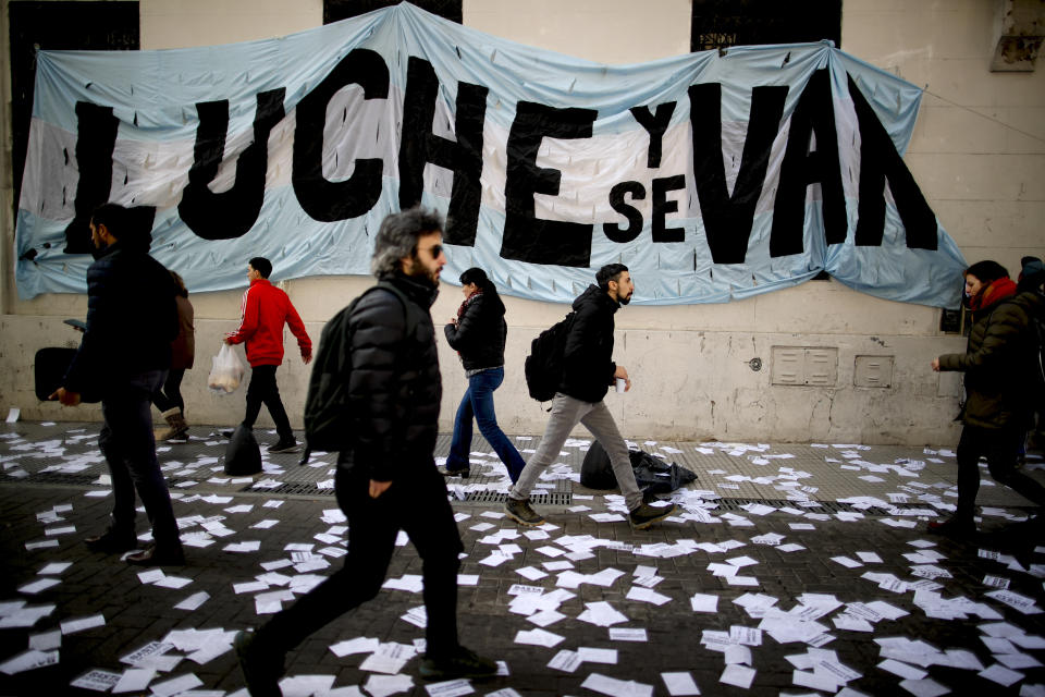 A banner with a message that reads in Spanish: "Fight and they will leave" in reference to President Mauricio Macri and his administration, hangs from a facade of the Central Bank during a demonstration in Buenos Aires, Argentina, Wednesday, Sept. 4, 2019. Social organizations are calling a food emergency and asking the government to provide food among other necessities. (AP Photo/Natacha Pisarenko)