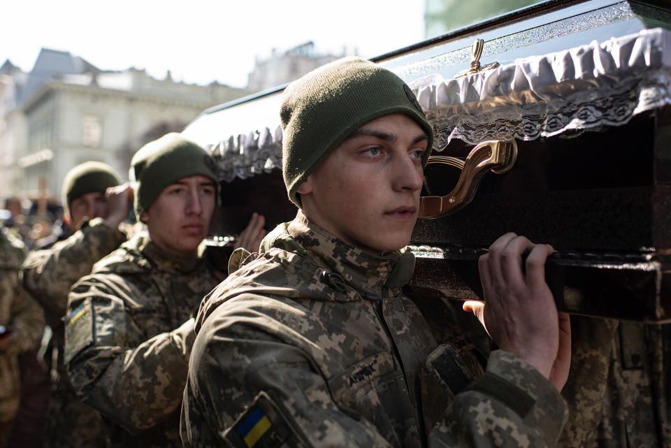 Ukrainian service members carry a coffin during a funeral service in Lviv, Ukraine, on March 15, 2022.