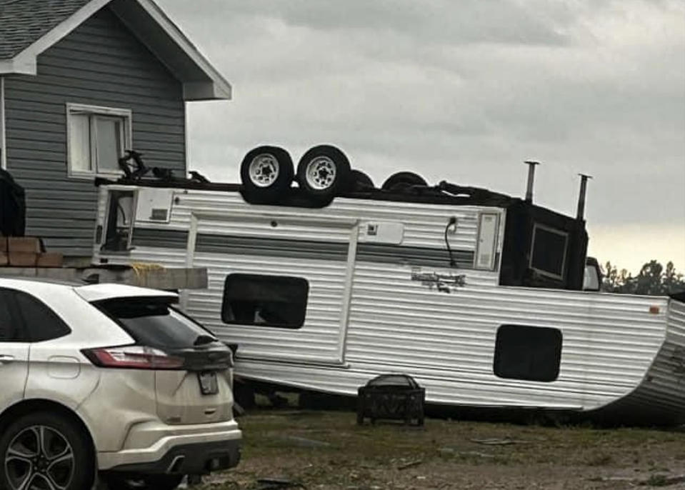 A trailer is seen flipped over from the intense wind in Carrot River on June 23.