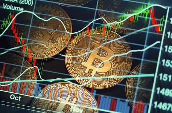 A stock chart is superimposed on several Bitcoin symbols.