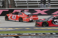 Bubba Wallace slides along the track during the NASCAR Cup Series auto race at Texas Motor Speedway in Fort Worth, Texas, Wednesday, Oct. 28, 2020. (AP Photo/Richard W. Rodriguez)