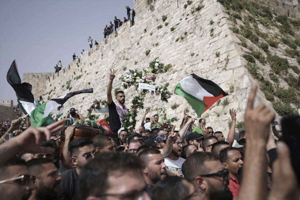 Mourners carry slain Al Jazeera veteran journalist Shireen Abu Akleh from her funeral in the Old City of Jerusalem to the cemetery, Friday, May 13, 2022. Abu Akleh, a Palestinian-American reporter who covered the Mideast conflict for more than 25 years, was shot dead Wednesday during an Israeli military raid in the West Bank town of Jenin. (AP Photo/Ariel Schalit)