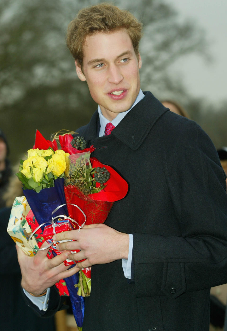 <p>William accepts flowers from a wellwisher as he leaves a Christmas Day service at Sandringham Church December 25, 2002. (Getty Images)</p> 