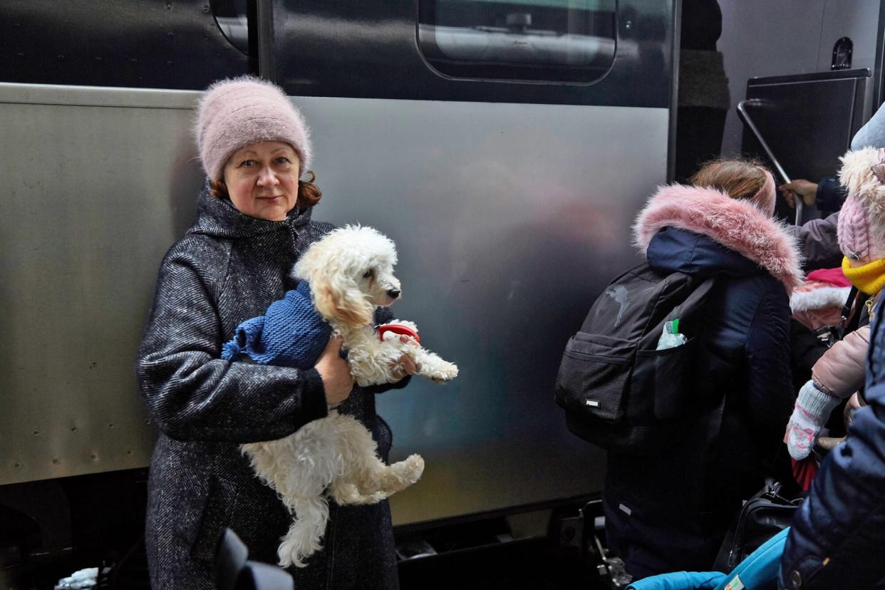 Ukraine woman holding her poodle waiting to board an evacuation train to western regions on March 1, 2022
