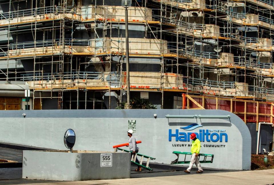 Construction workers are seen at the Hamilton on the Bay on Friday, Aug. 27, 2021.