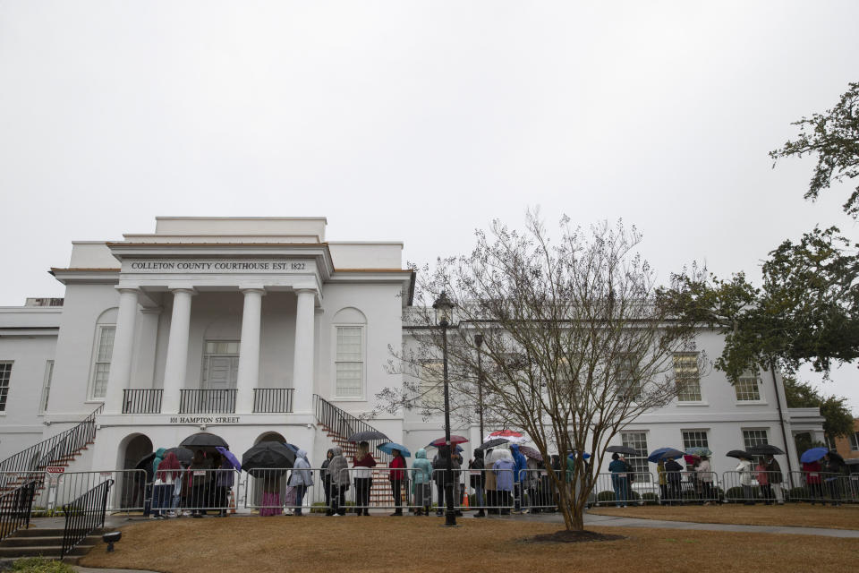 People wait outside of the courthouse on Friday.