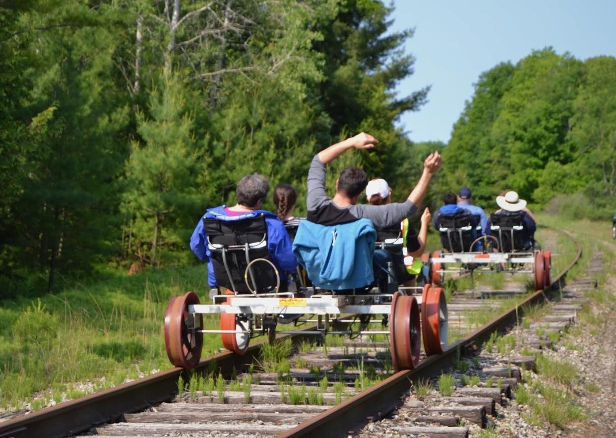 Customers ride rail bikes in Grawn, 10 miles outside of Traverse City, during Wheels on Rails opening season in summer 2023.