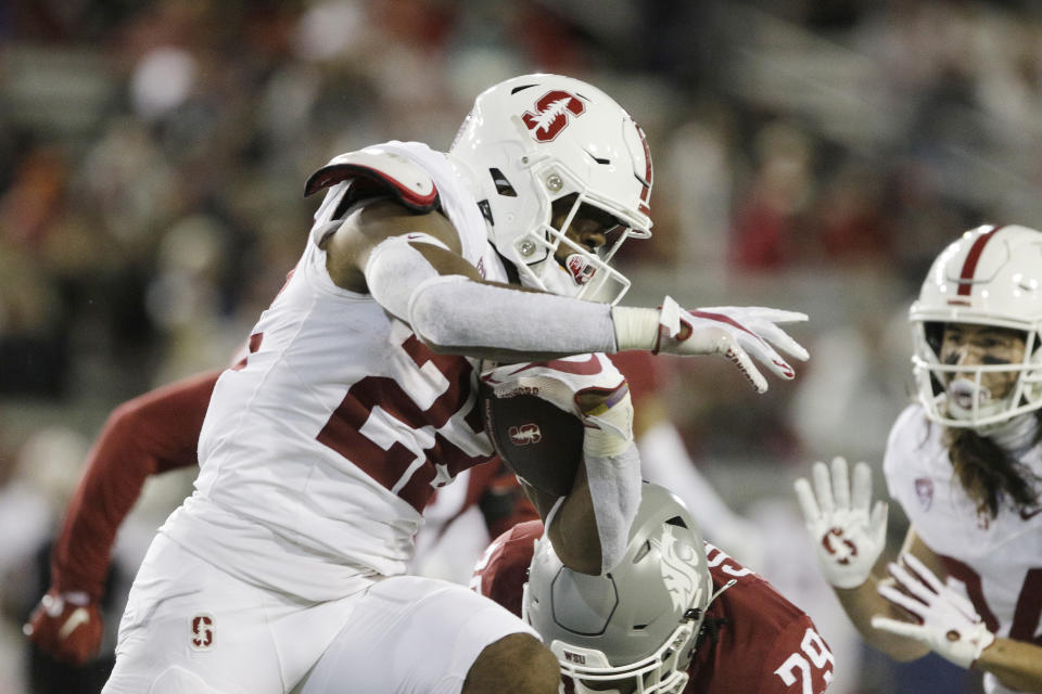 Stanford running back E.J. Smith (22) carries the ball while pressured by Washington State defensive back Jamorri Colson (29) during the second half of an NCAA college football game, Saturday, Nov. 4, 2023, in Pullman, Wash. Stanford won 10-7. (AP Photo/Young Kwak)