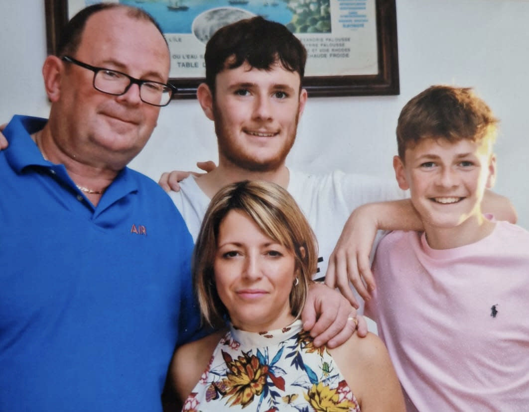 Luke Abrahams (centre) with his family - father Richard (left), mother Julie Needham, 49, and younger brother Jake, 16 (right). (SWNS)