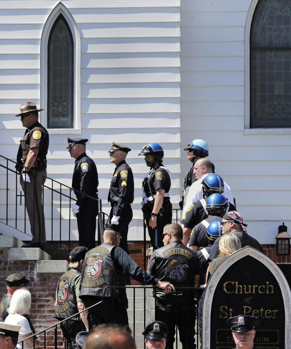 Police officers and members of the Jarheads Motorcycle Club wait in line for the funeral of Michael Ferazzi at St. Peter's Catholic Church in Plymouth, Mass., Friday, June 28, 2019. Ferazzi, a motorcyclist and retired police officer, was killed in a fiery crash that claimed the lives of seven people riding with the Jarheads Motorcycle Club in New Hampshire. (AP Photo/Charles Krupa)