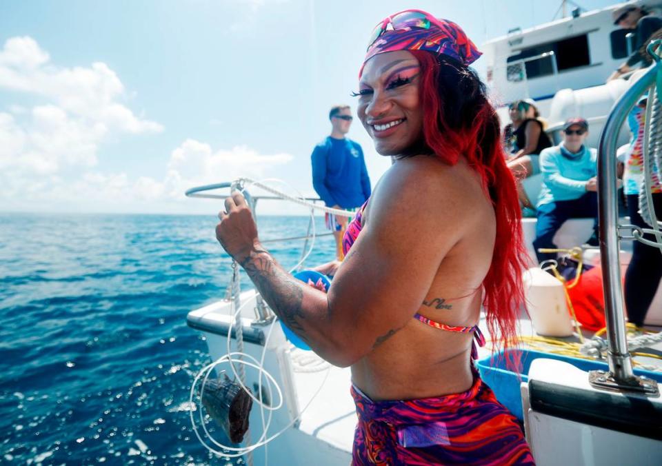 Miss Toto poses with a chunk of bait attached a circle hook during the Drag and Tag event on September 16, 2023 aboard the RV Garvin off the coast of Miami, Florida. (Photo by Cliff Hawkins/Field School)