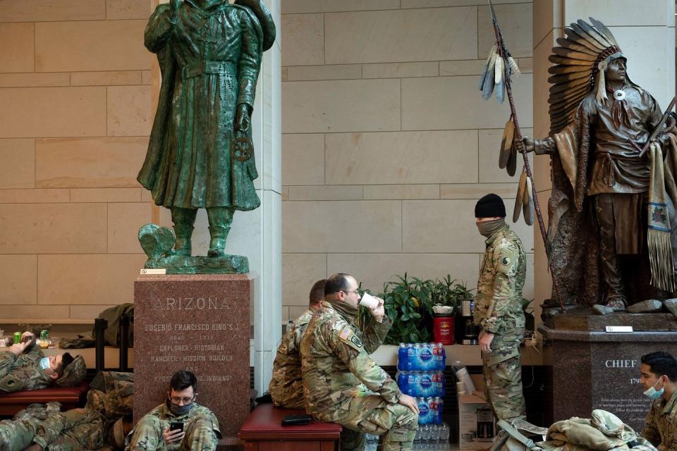 <p>Members of the National Guard rest in the Capitol Visitors Center on Capitol Hill in Washington, DC, January 13, 2021</p>