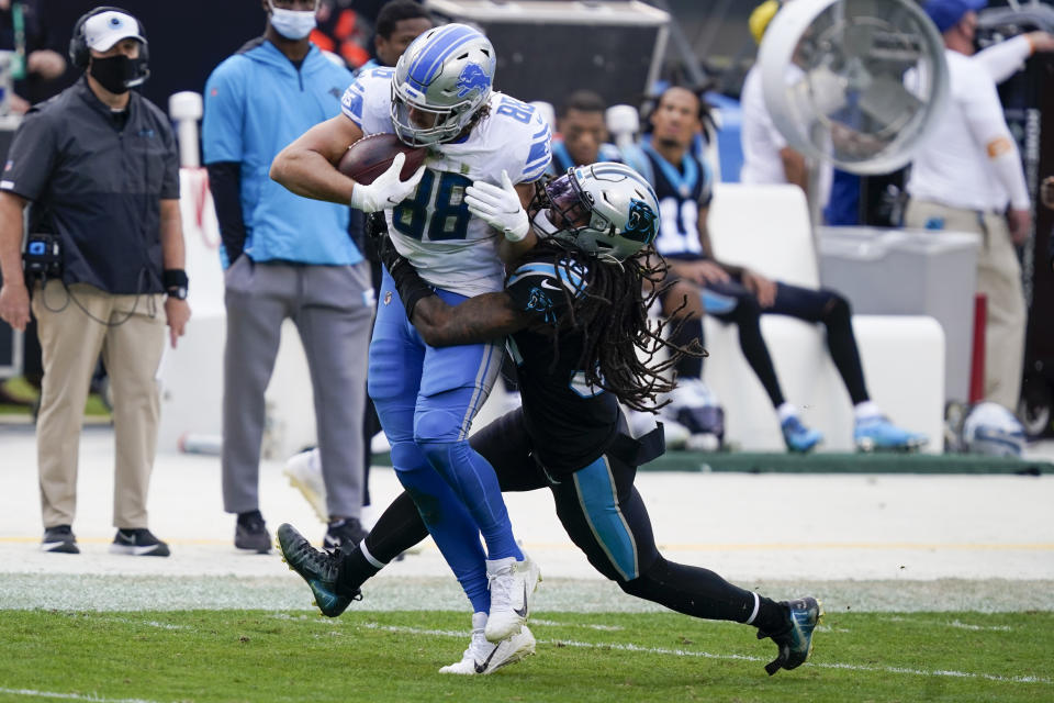 Detroit Lions tight end T.J. Hockenson is tackled by Carolina Panthers free safety Tre Boston during the second half of an NFL football game Sunday, Nov. 22, 2020, in Charlotte, N.C. (AP Photo/Gerry Broome)