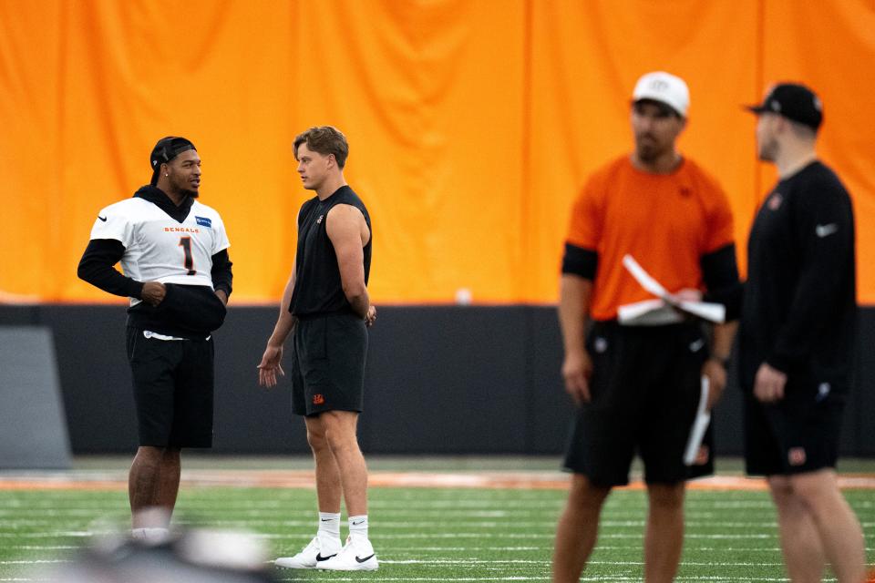 Cincinnati Bengals wide receiver Ja'Marr Chase (1) and Cincinnati Bengals quarterback Joe Burrow (9) talk at Bengals spring practice at the IEL Indoor Facility in Cincinnati on Thursday, June 13, 2024.