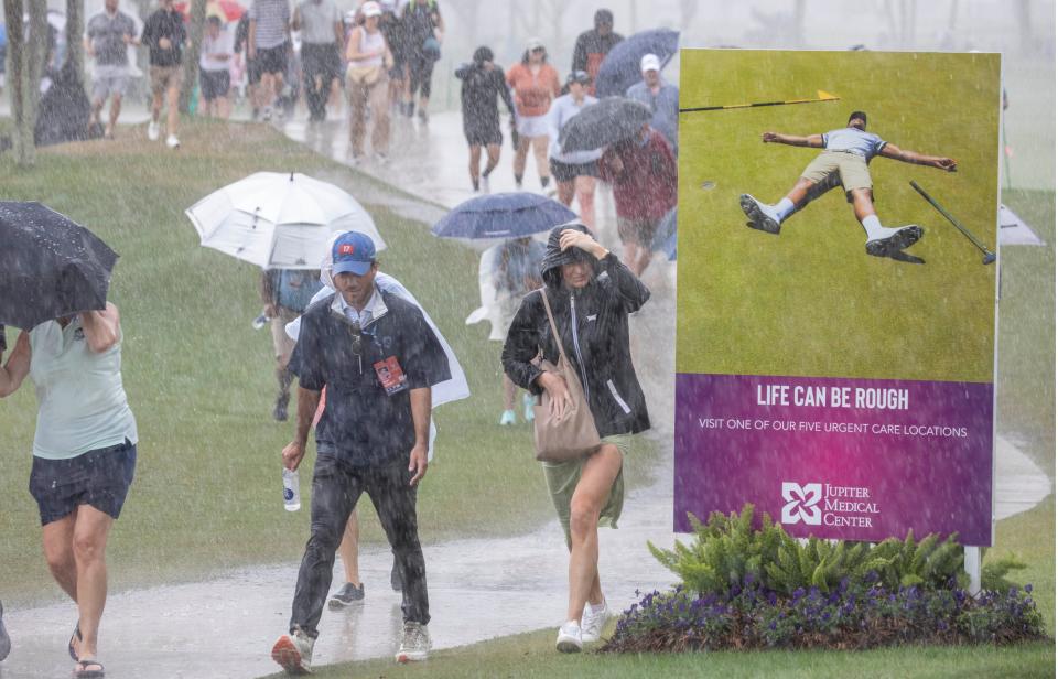 Fans leave run for cover during a thunderstorm at the final round of The Cognizant Classic in The Palm Beaches at PGA National Resort & Spa on March 1, 2024 in Palm Beach Gardens, Florida.