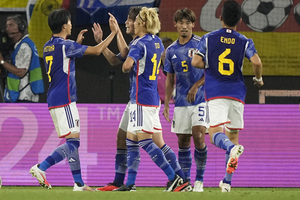 Japan's Ayase Ueda, centre left, celebrates after scoring his side's second goal during an international friendly soccer match between Germany and Japan in Wolfsburg, Germany, Saturday, Sept. 9, 2023. (AP Photo/Martin Meissner)