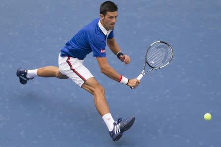 Novak Djokovic of Serbia chases down a return against Joao Souza of Brazil during their match at the U.S. Open Championships tennis tournament in New York, August 31, 2015. REUTERS/Adrees Latif