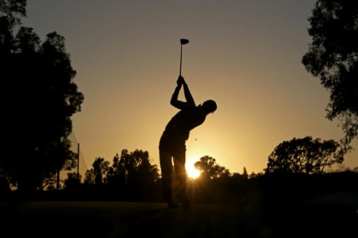 American Justin Thomas hits his tee shot at the second hole of the third round at the weather-disrupted Genesis Open, not long before darkness halted play