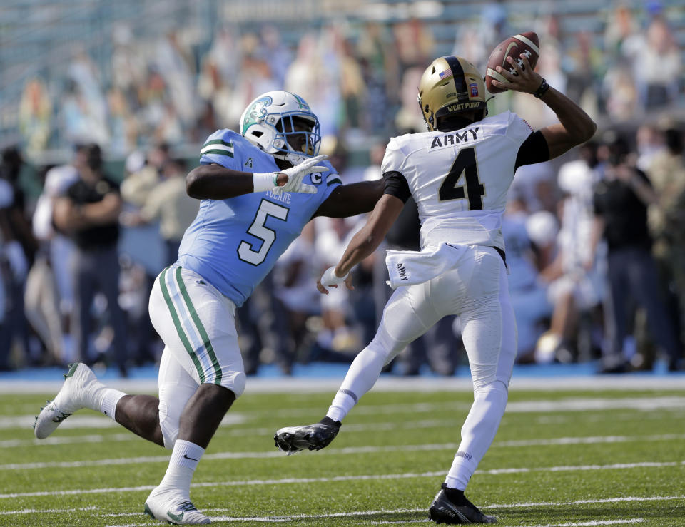 Tulane defensive end Cameron Sample (5) applies pressure to Army quarterback Christian Anderson (4) during an NCAA college football game in New Orleans, La., Saturday, Nov. 14, 2020. (A. J. Sisco/The Advocate via AP)
