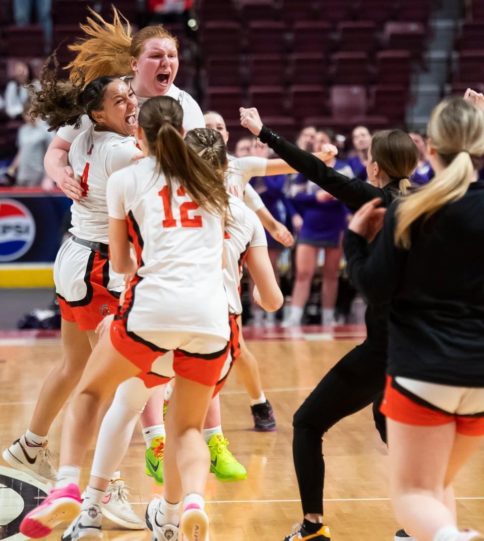 York Suburban players celebrate on the court after defeating Northern York, 37-35, in overtime in the District 3 Class 5A girls' basketball championship at the Giant Center on March 1, 2024, in Hershey.