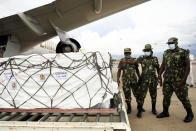 Malawian police guard AstraZeneca COVID-19 vaccines after the shipment arrived at the Kamuzu International Airport in Lilongwe, Malawi, Friday March 5, 2021. The country is the latest in Africa to receive vaccines in a fight against COVID-19. (AP Photo/Thoko Chikondi)
