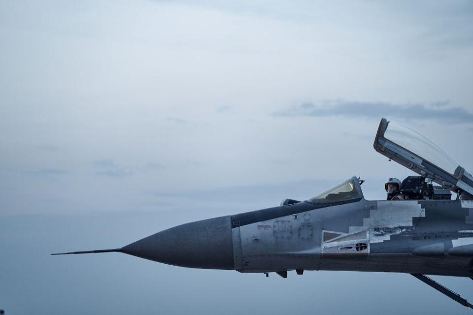 A Ukrainian Tactical Aviation pilot poses in the cockpit of his MIG-29 fighter jet at sunset on August 1, 2023, in eastern Ukraine.