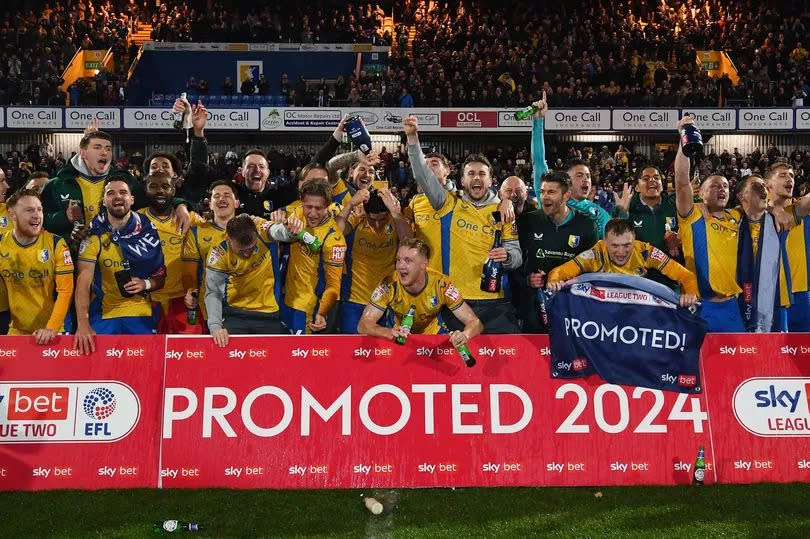 Mansfield Town celebrate promotion to League One -Credit:Anna Gowthorpe/EFL