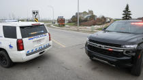 <p>Police vehicles block the entrance to the evacuated neighbourhood of Beacon Hill in Fort McMurray, Alta., on Wednesday, May 15, 2024. THE CANADIAN PRESS/Jeff McIntosh</p> 