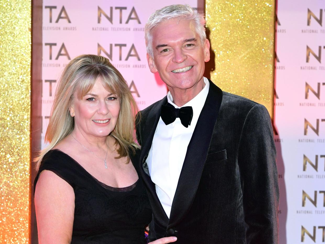 Phillip Schofield (right) and his wife Stephanie Lowe (PA)