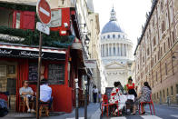 People sit on the terrace of a cafe in Paris, Tuesday, June 2, 2020. Paris City Hall authorized the reopening of outside seating areas but indoor tables remain closed to customers until at least June 22. (AP Photo/Thibault Camus)