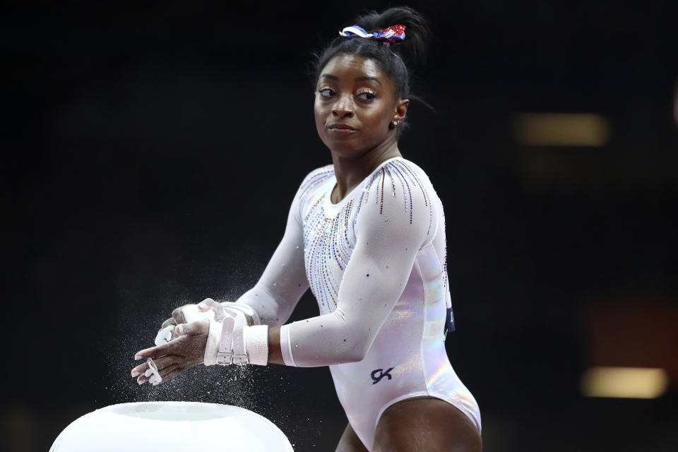 FILE - In this Oct. 10, 2019, file photo, Simone Biles of the United States gets ready to perform on the uneven bars in the women's all-around final at the Gymnastics World Championships in Stuttgart, Germany. Biles is pressing on to the 2021 Olympics. While she's confident her body will be fine next summer, she is concerned about the mental toll of another year of training. (AP Photo/Matthias Schrader, Fle)