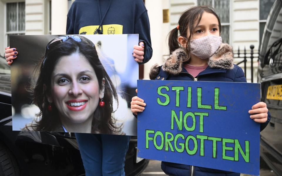 Richard Ratcliffe (not seen) the husband of Nazanin Zaghari-Ratcliffe, with his daughter Gabriella during a protest outside the Iranian Embassy in London in March - FACUNDO ARRIZABALAGA/EPA-EFE/Shutterstock 