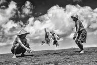 Jino Lee, from Malaysia, captures two farmers indulging in their favourite pastime - a round of a friendly rooster fight in Indonesia (Travel Photographer of the Year)