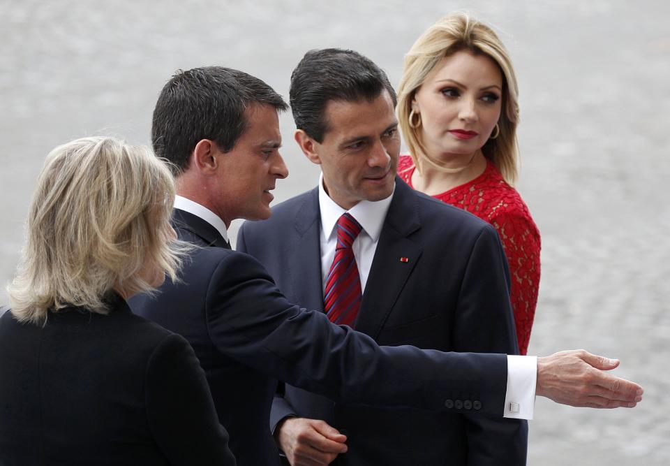 French Prime Minister Manuel Valls, Mexico's President Enrique Pena Nieto and Mexico's First Lady Angelica Rivera attend the traditional Bastille Day military parade in Paris