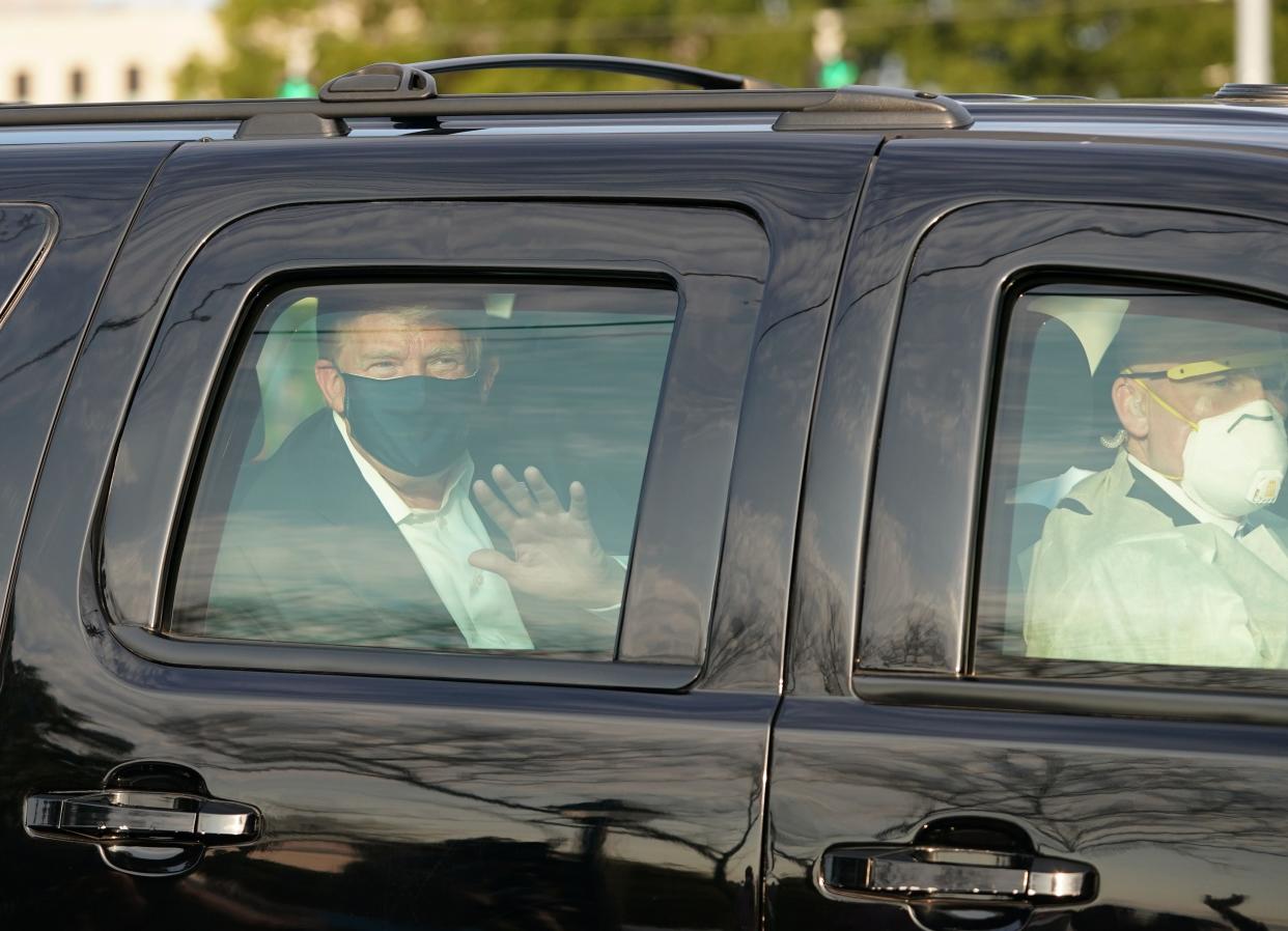 US president Trump waves from the back of a car in a motorcade outside of Walter Reed Medical Centre in Bethesda, Maryland on 4 October 2020 ((AFP via Getty Images))