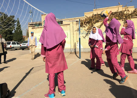 Iranian and Afghan girls play volleyball with workers of the U.N. refugee agency UNHCR at the Emam Hasan Mojtaba school in Kerman, Iran, October 23, 2016. REUTERS/Gabriela Baczynska