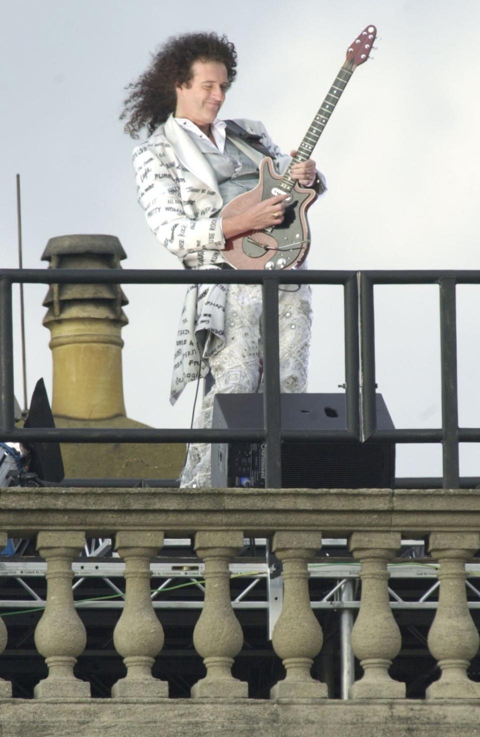 Brian May plays the national anthem from the roof of Buckingham Palace (Stefan Rousseau/PA) (PA Archive)