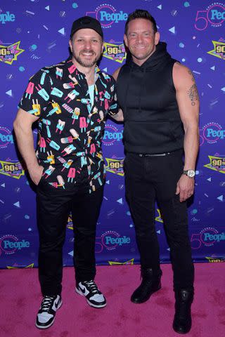 <p>Stephen Lovekin/ Shutterstock</p> Drew Lachey (left) and Jeff Timmons attend 90s Con