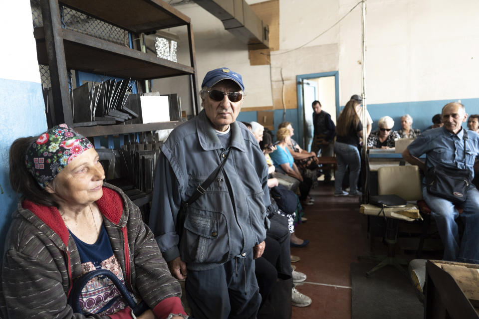 People sit in a workshop in Kyiv, Ukraine, May 30, 2023, in a manufacturing plant where visually impaired people used to work until it was shuttered following a Russian air assault. Losing the place of work is just one of a multitude of challenges that people with visual impairments face across Ukraine since Russia launched a full-scale invasion in February 2022. (AP Photo/Roman Hrytsyna)