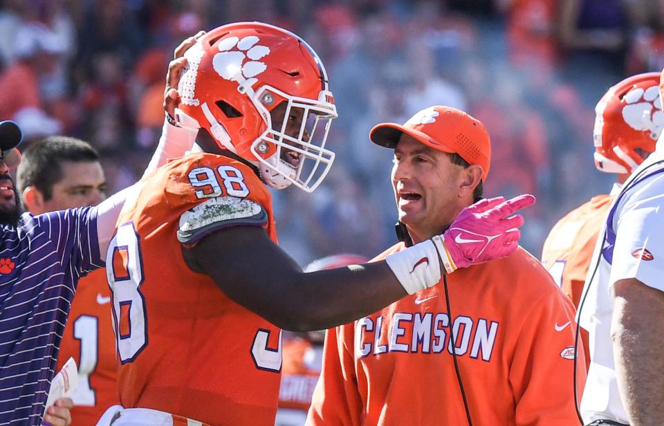 Clemson head coach Dabo Swinney talks with Clemson defensive end Myles Murphy (98) during the fourth quarter at Memorial Stadium in Clemson, South Carolina Saturday, October 22, 2022.   