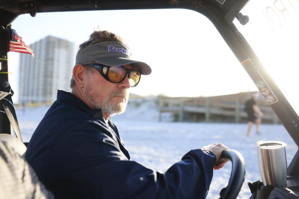 Kevin Brown patrols in the little vehicle he uses when he's at work with the Beaches Sea Turtle Patrol. His visor has a logo he came up with, "Beachneck," a person he defines this way: "You don’t like to leave the island. You defend the island."