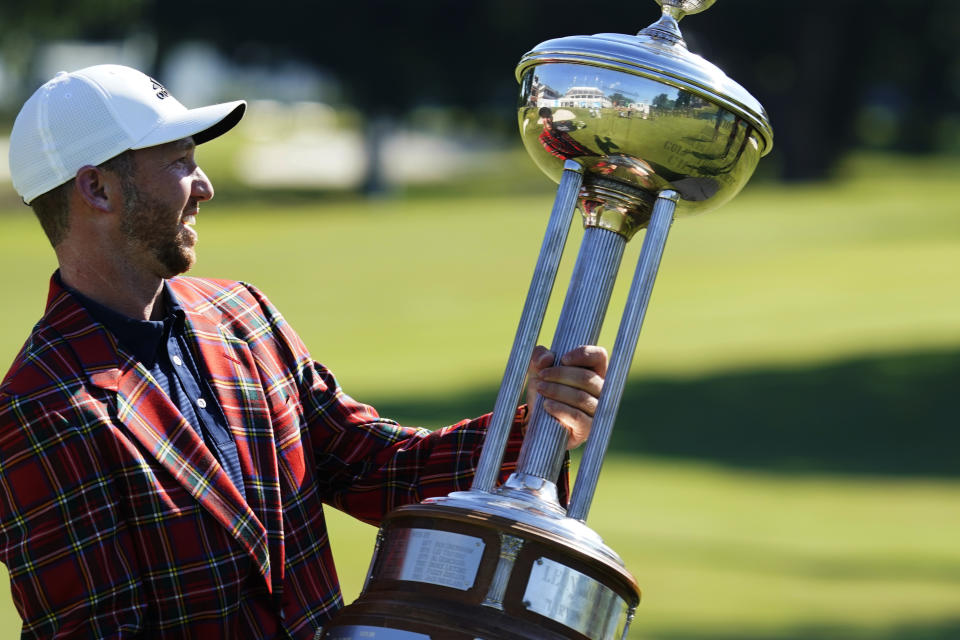 Daniel Berger poses with the championship trophy after winning the Charles Schwab Challenge golf tournament after a playoff round at the Colonial Country Club in Fort Worth, Texas, Sunday, June 14, 2020. (AP Photo/David J. Phillip)