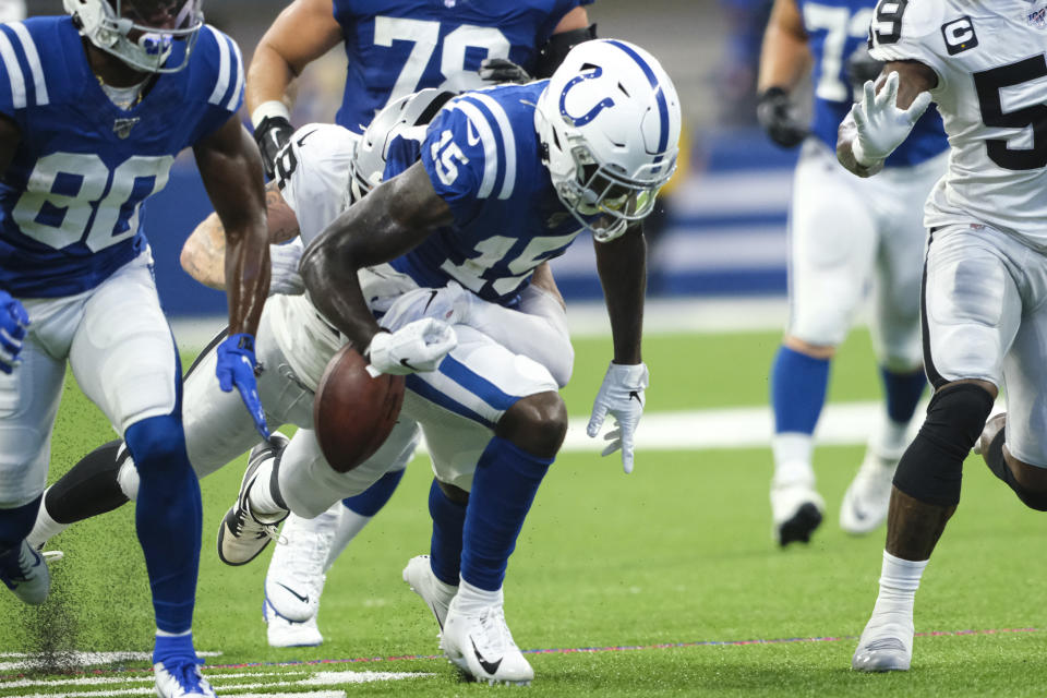 Oakland Raiders defensive end Maxx Crosby (98) strips the ball from Indianapolis Colts wide receiver Parris Campbell (15) during the first half of an NFL football game in Indianapolis, Sunday, Sept. 29, 2019. The Raiders recovered the fumble. (AP Photo/AJ Mast)