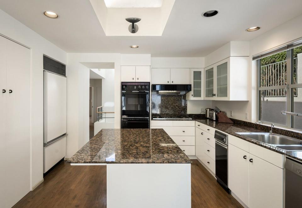 a kitchen with white cabinets