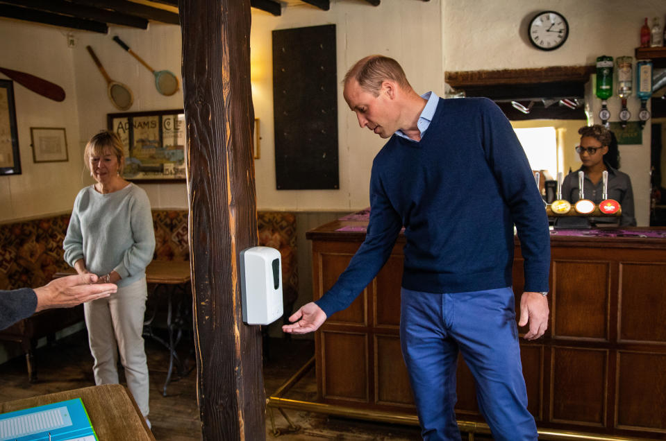 EMBARGOED TO 2230 BST FRIDAY JULY 3 The Duke of Cambridge uses hand sanitiser as he enters The Rose and Crown pub in Snettisham, Norfolk.